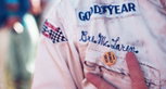 Bruce McLaren shows his newest 'medal' in the paddock at Watkins Glen, 1969. Bruce McLaren shows his newest 'medal' in the paddock at Watkins Glen, 1969.