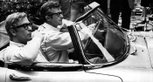 Michael Caine and director Bryan Forbes driving an E-type at the set of 'Deadfall' (1968).